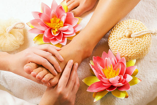 Client enjoying calming hand and foot reflexology at reflexology123.com in a peaceful setting.